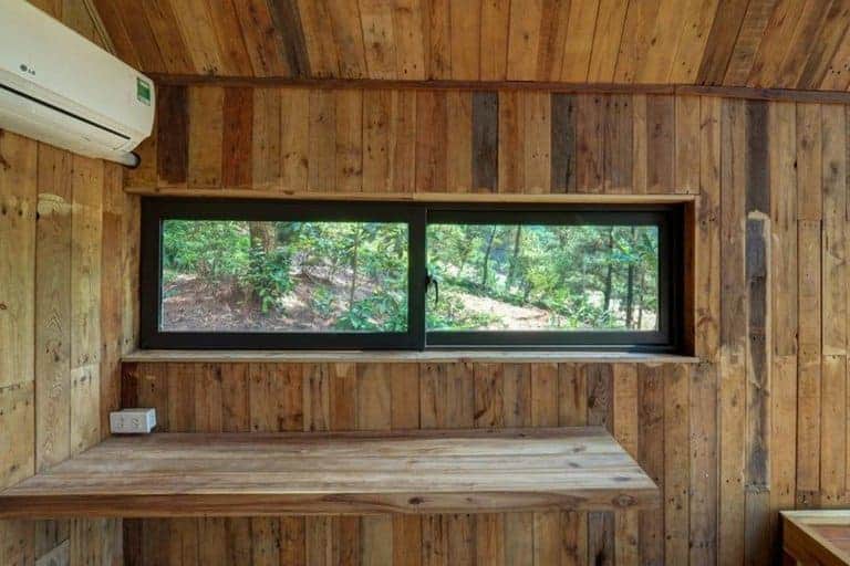 glass walled cabin built on stilts