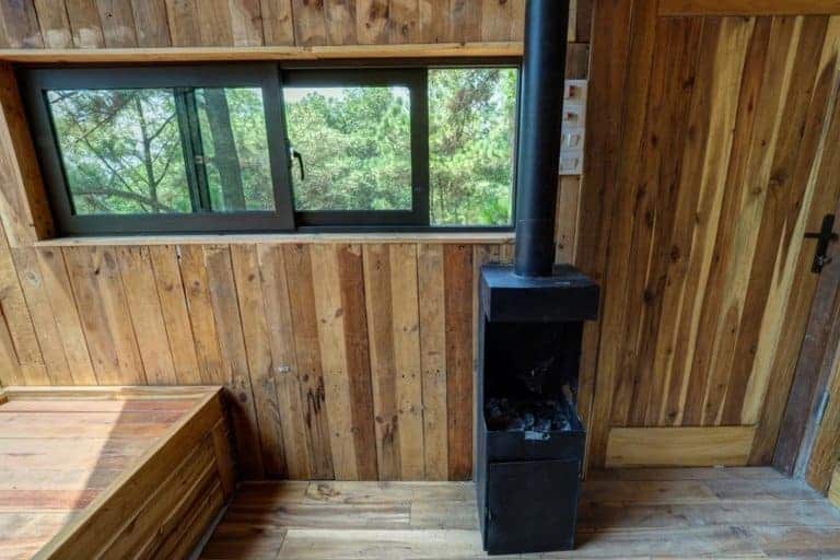glass walled cabin built on stilts